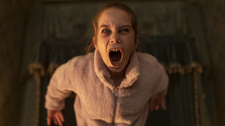 Abigail screaming, showing off all of her pointed teeth