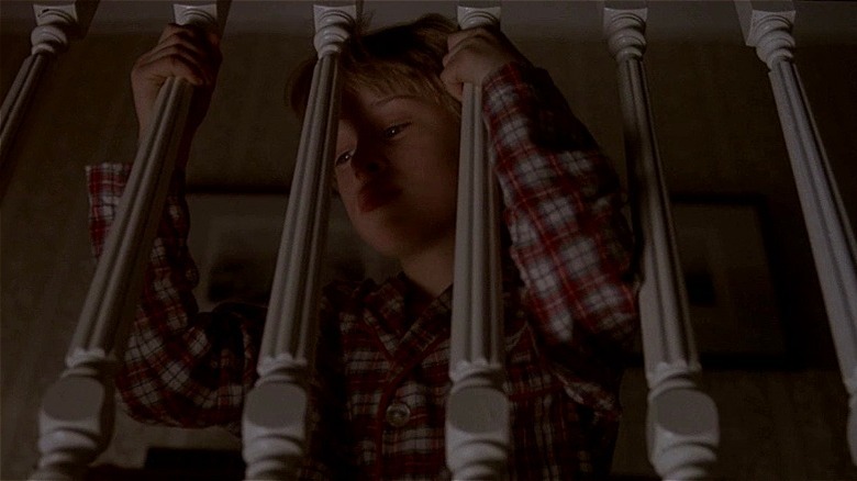 Henry peering through stair railing in The Good Son (1993)