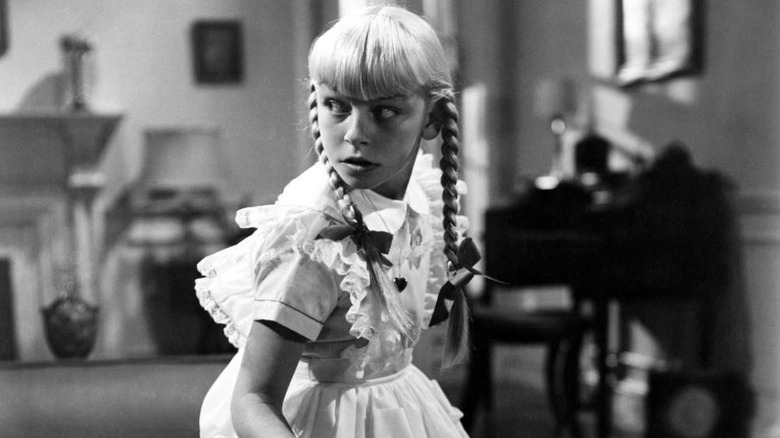 Rhoda looking over her shoulder in The Bad Seed (1956)