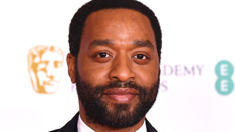 Chiwetel Ejiofor smiling in suit