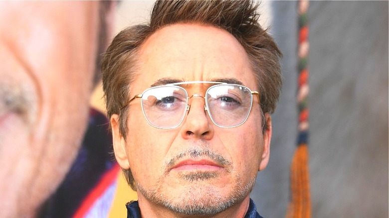 Robert Downey Jr. wearing glasses and looking upward