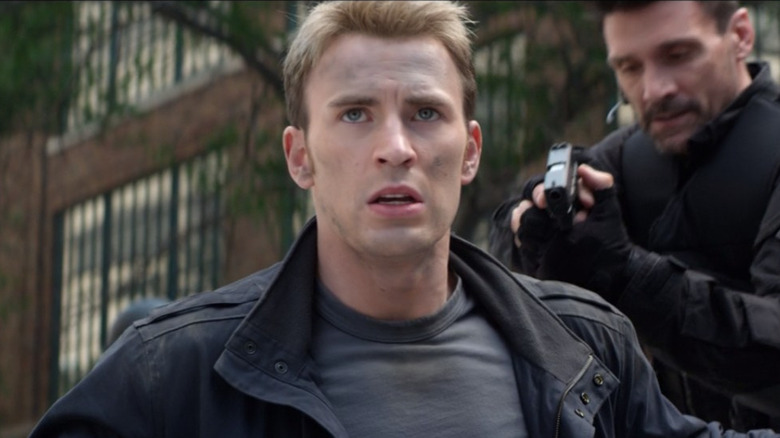 Crossbones pointing gun at Cap