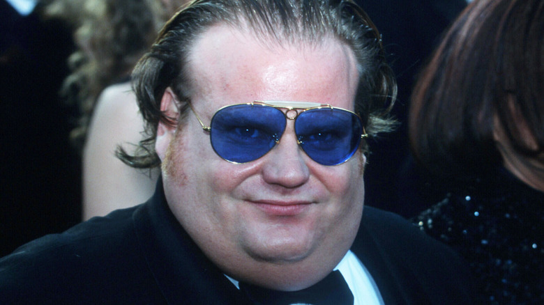 Chris Farley wears blue-tinted sunglasses