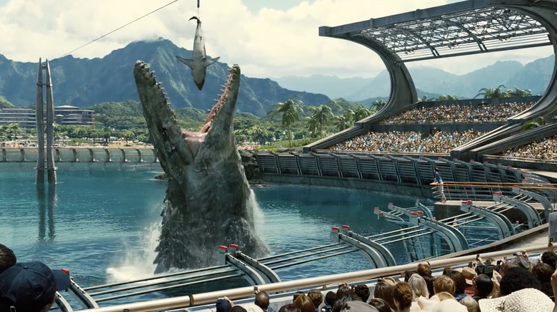 Mosasaurus eating shark in front of crowd