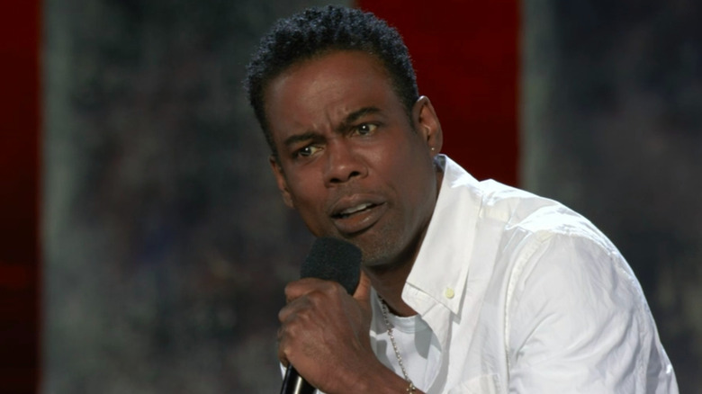 Chris Rock white shirt on stage holding mic