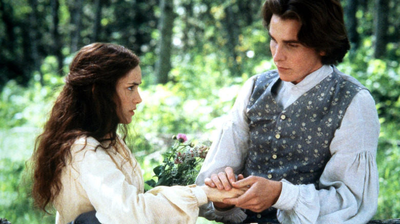 Laurie caressing Jo's hand in a field in Little Women (1994)