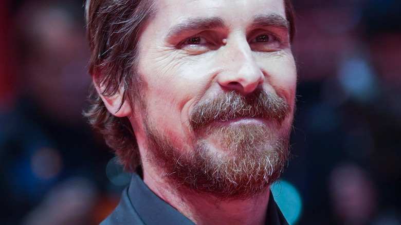 Christian Bale smiling for the press