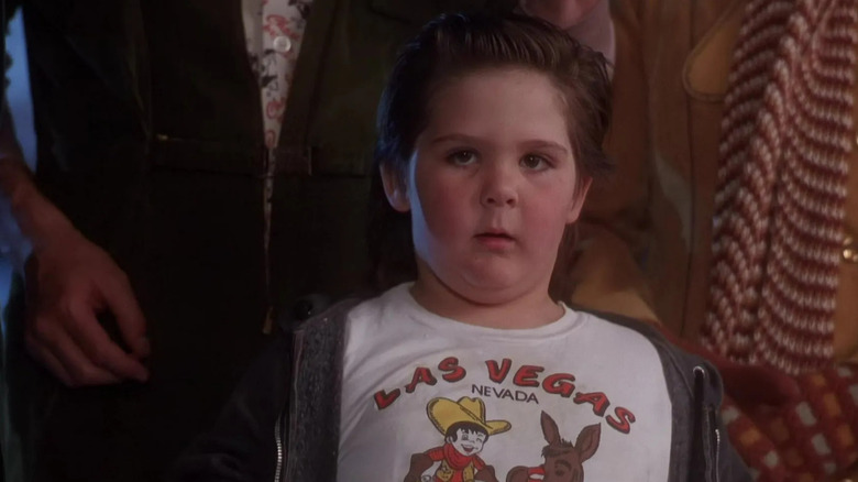 Little Rocky Johnson standing by parents in National Lampoon's Christmas Vacation (1983)