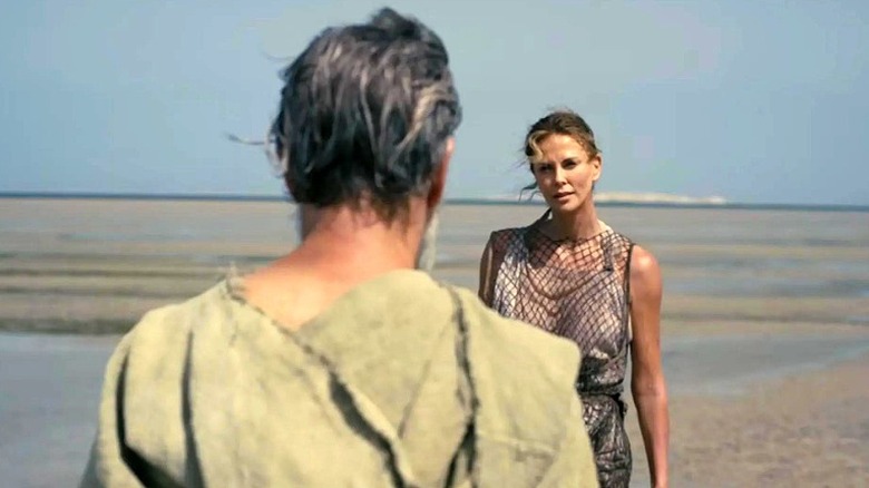 Odysseus and Calypso on a beach in "The Odyssey" (2026)