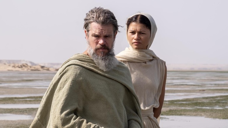 Athena standing behind Odysseus in The Odyssey (2026)