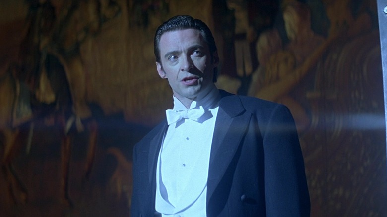 Robert Angier standing in spotlight