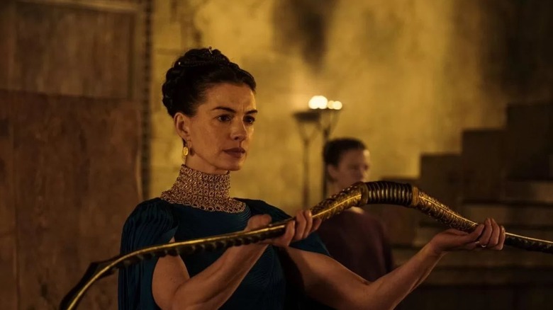 Penelope holding Odysseus' famed bow in The Odyssey