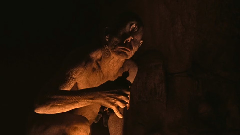The cyclops holding a soldier to eat in The Odyssey