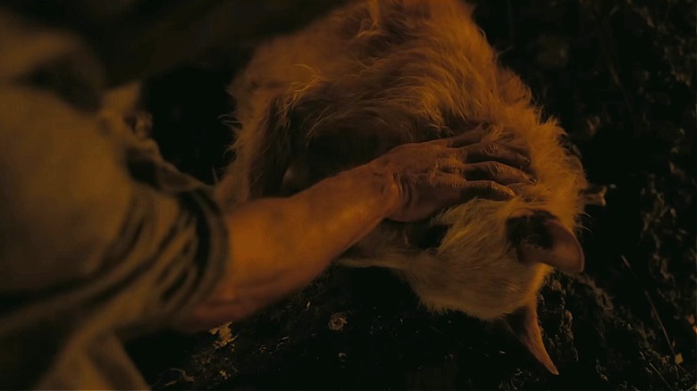 Odysseus petting Argos one last time in The Odyssey