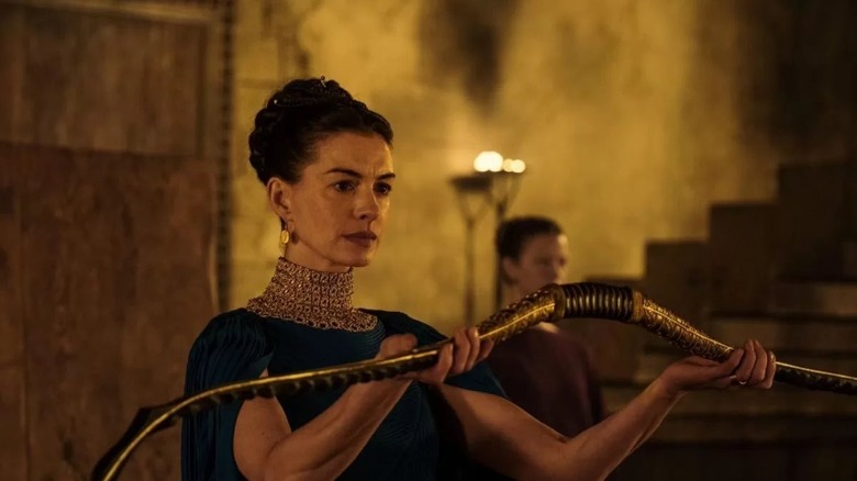 Penelope holding Odysseus' hunting bow in The Odyssey