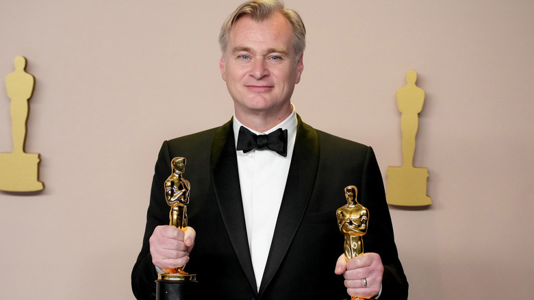 Christopher Nolan holding Oscars