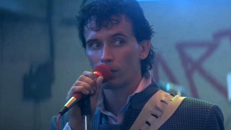 Buckaroo Bonzai holding a microphone in "The Adventures of Buckaroo Bonzai" (1984)