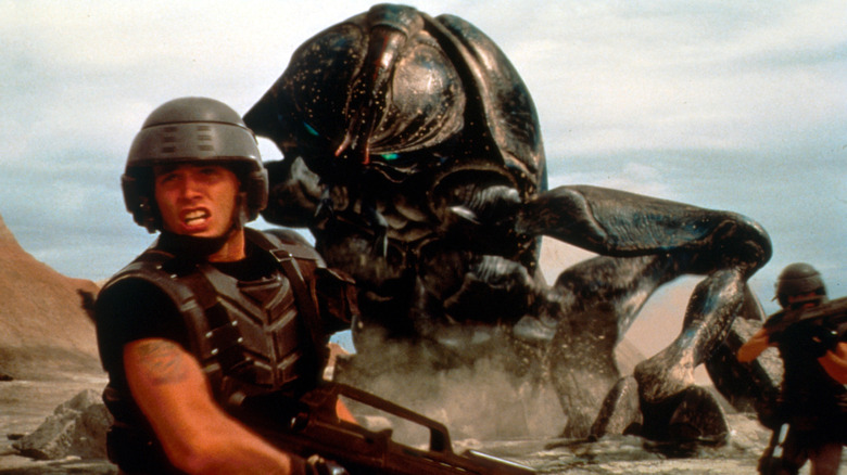 Rico running from an Arachnid in Starship Troopers (1997)