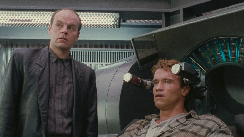 Richter standing next to Quaid, who's rigged into a Rekall machine, in Total Recall (1990)