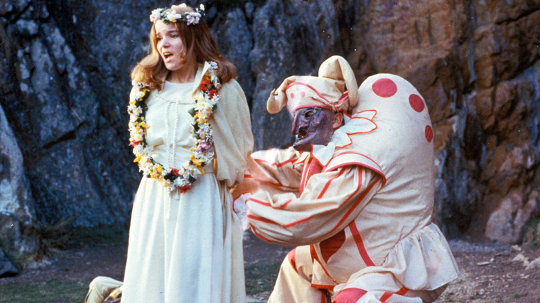 A court jester ties a bride's hands together in "The Wicker Man" (1973)