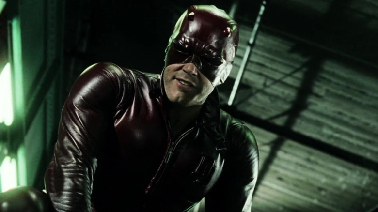 Daredevil leaning down over a thug he's just defeated in Daredevil (2003)