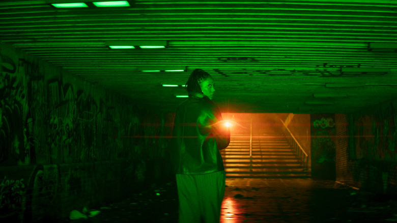 Dr. Caitlyn Corr walking through an alley in Clayface