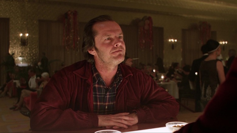 Jack Torrence sitting at bar counter in 