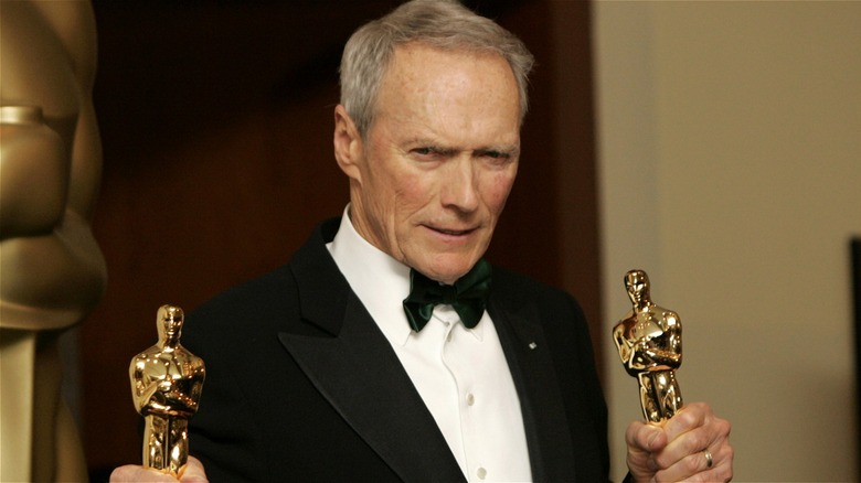 Clint Eastwood holding up Oscars for "Million Dollar Baby"