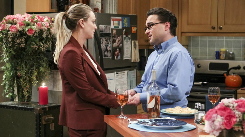 Penny and Leonard drinking wine at the kitchen counter on The Big Bang Theory
