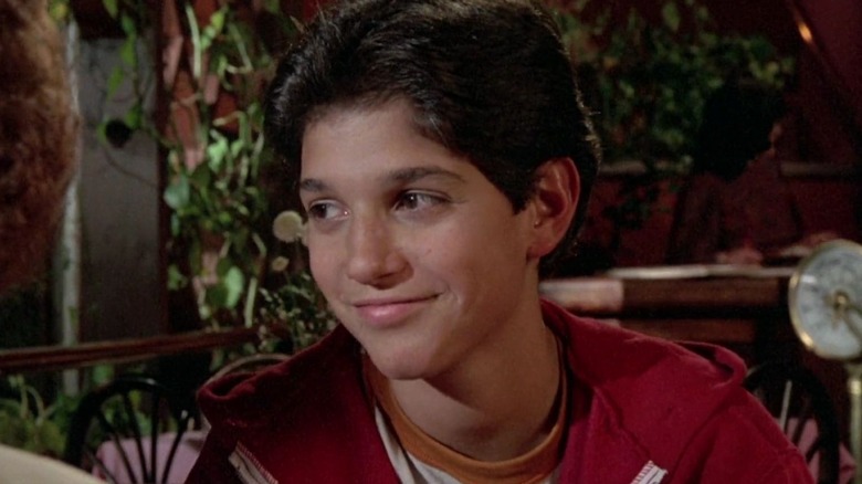 Daniel LaRusso smiling and looking to side