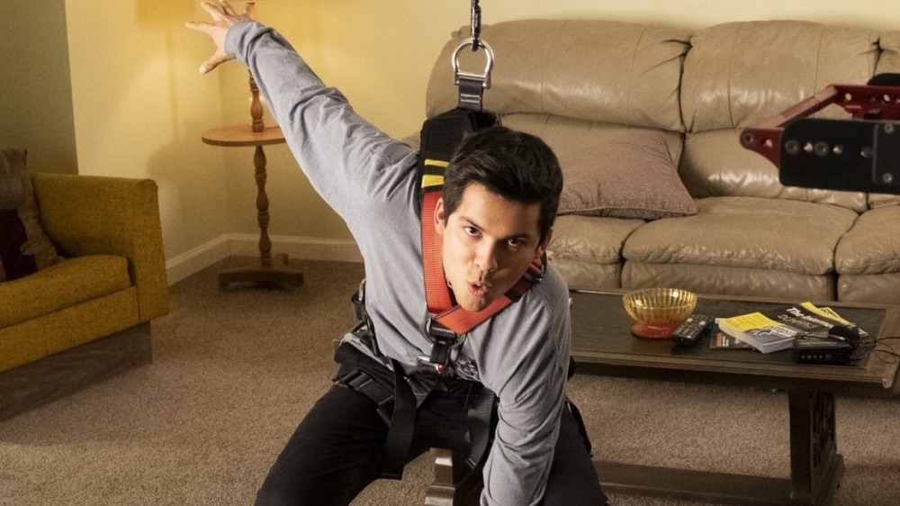 Xolo Mariduena does martial arts in a living room