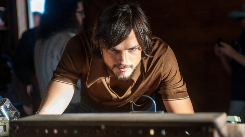 Ashton Kutcher as a bearded Steve Jobs working on computer in Jobs (2013)