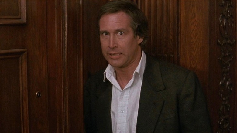 Nick looking nervous in front of door in Memoirs of an Invisible Man (1992)