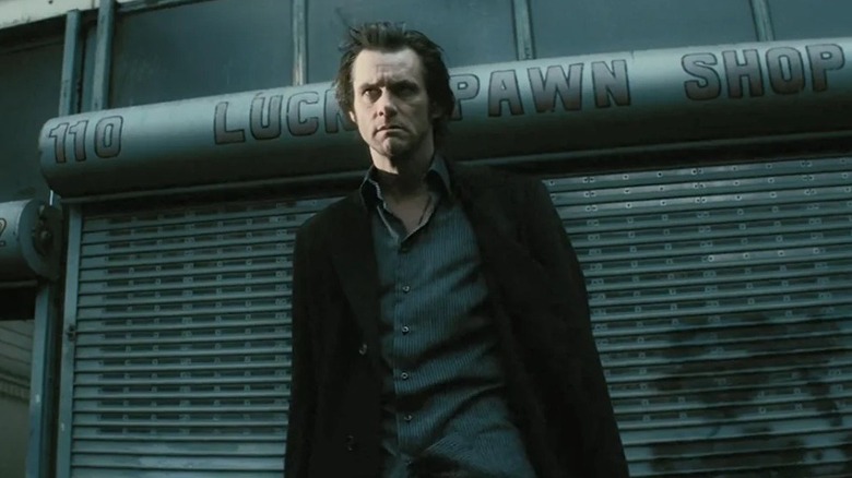 Walter standing in front of a shuttered pawn shop in The Number 23 (2007)