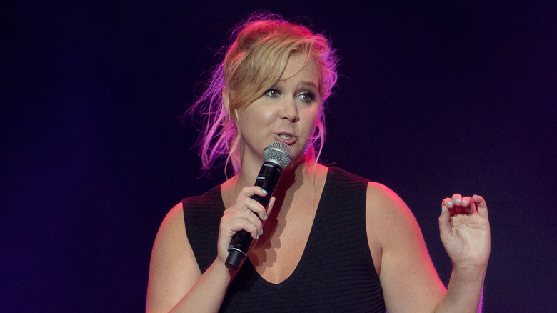 Amy Schumer talking into a microphone