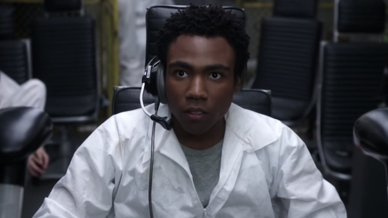 Troy sits in lab coat