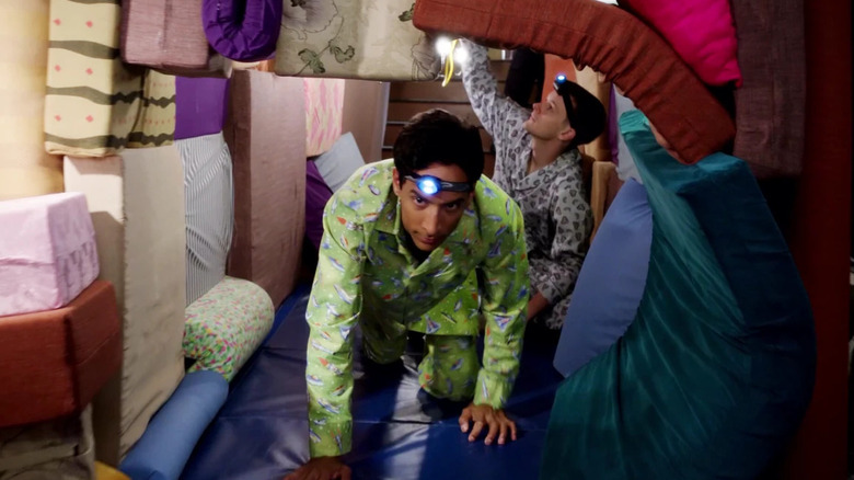 Abed crawling through a pillow tunnel in "Pillows and Blankets" (2012)