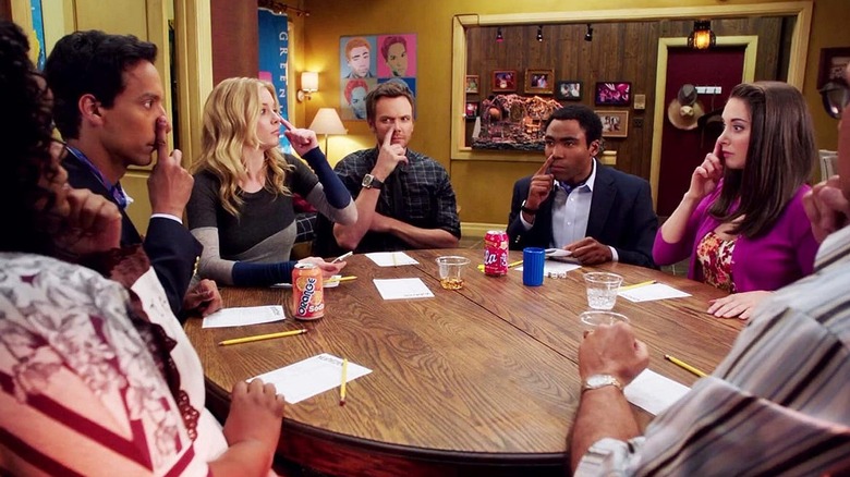 The study group around a table touches their noses to avoid getting pizza in "Remedial Chaos Theory" (2011)