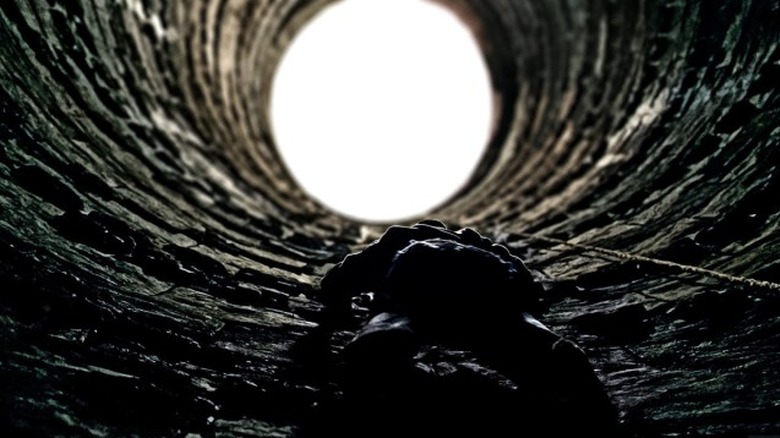 Bruce climbing out of a hole