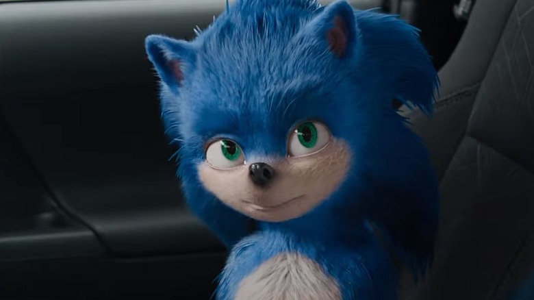 Ugly Sonic smiles in a car
