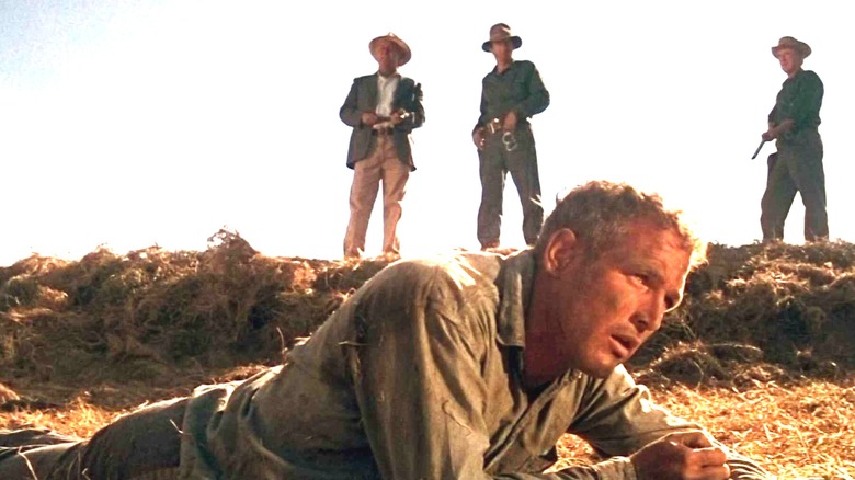 Three men standing over Luke in 