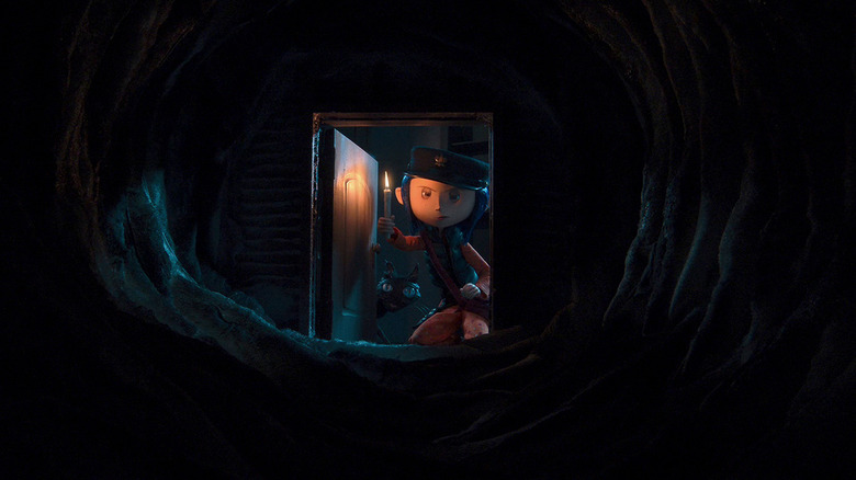 Coraline looking down dark tunnel