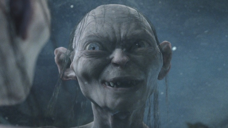 Gollum talks to himself in his reflection in the water in "The Two Towers" (2002)