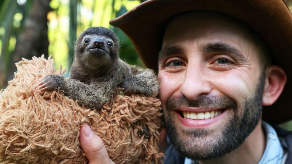 Coyote Peterson with a baby sloth