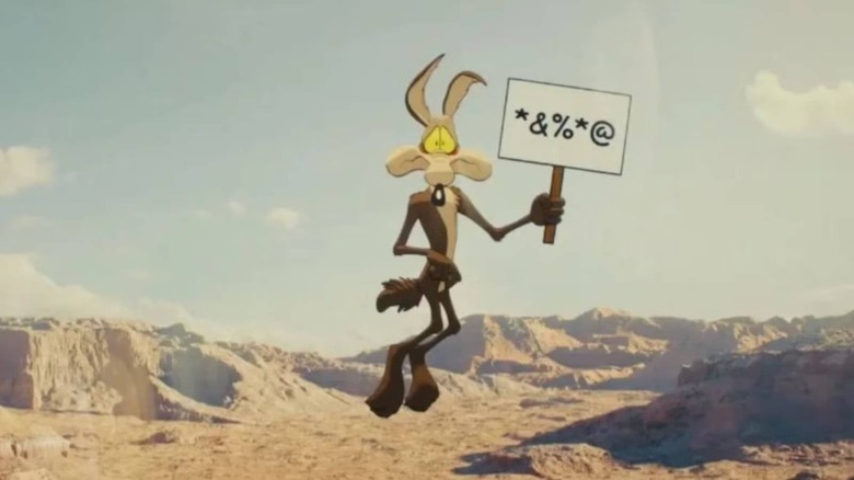 Wile E. Coyote holding a sign in Coyote vs. Acme