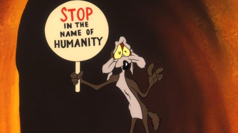 Wile E. Coyote holding a sign
