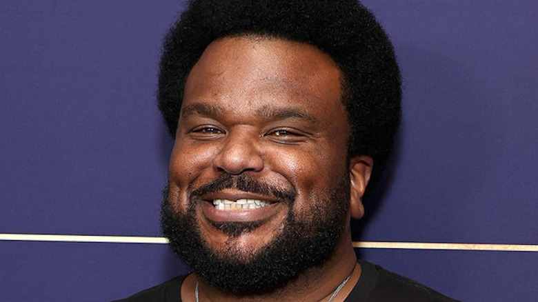 Craig Robinson smiling at a press event