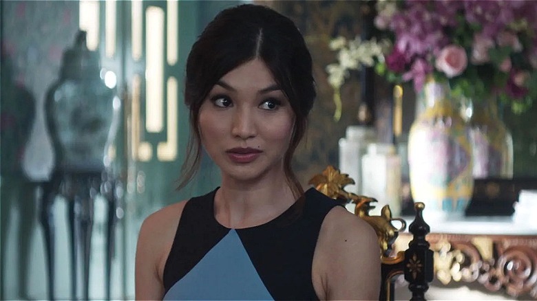 Astrid sitting in a gilded chair in "Crazy Rich Asians"