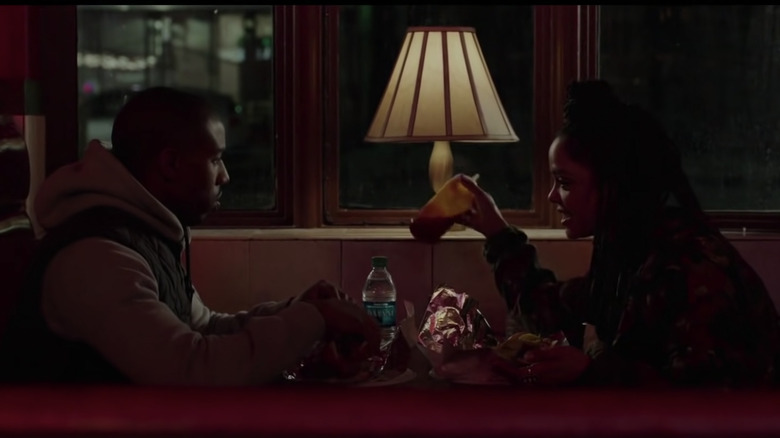 Bianca and Adonis Creed sitting in booth