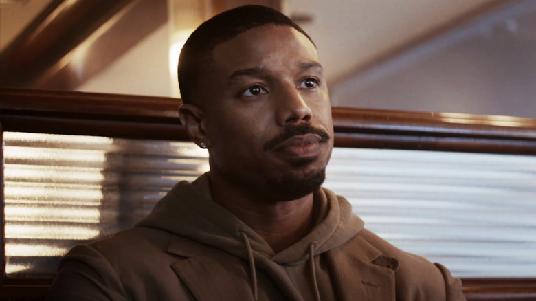 Adonis Creed sitting in booth 
